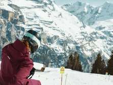Two people are riding a sled on the bobsled run in Mürren. 