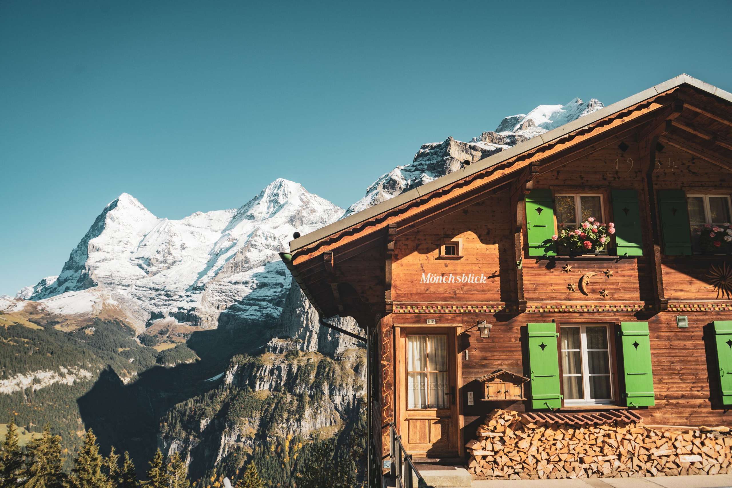 View from Mürren, the Chalet Mönchsblick, of the Eiger and Mönch. Both mountains are covered in snow.