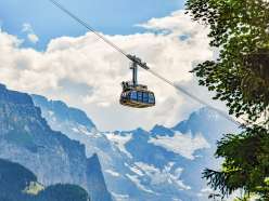 The LWM gondola with the Royal Ride on its roof. In the background is the snow-covered mountain panorama.