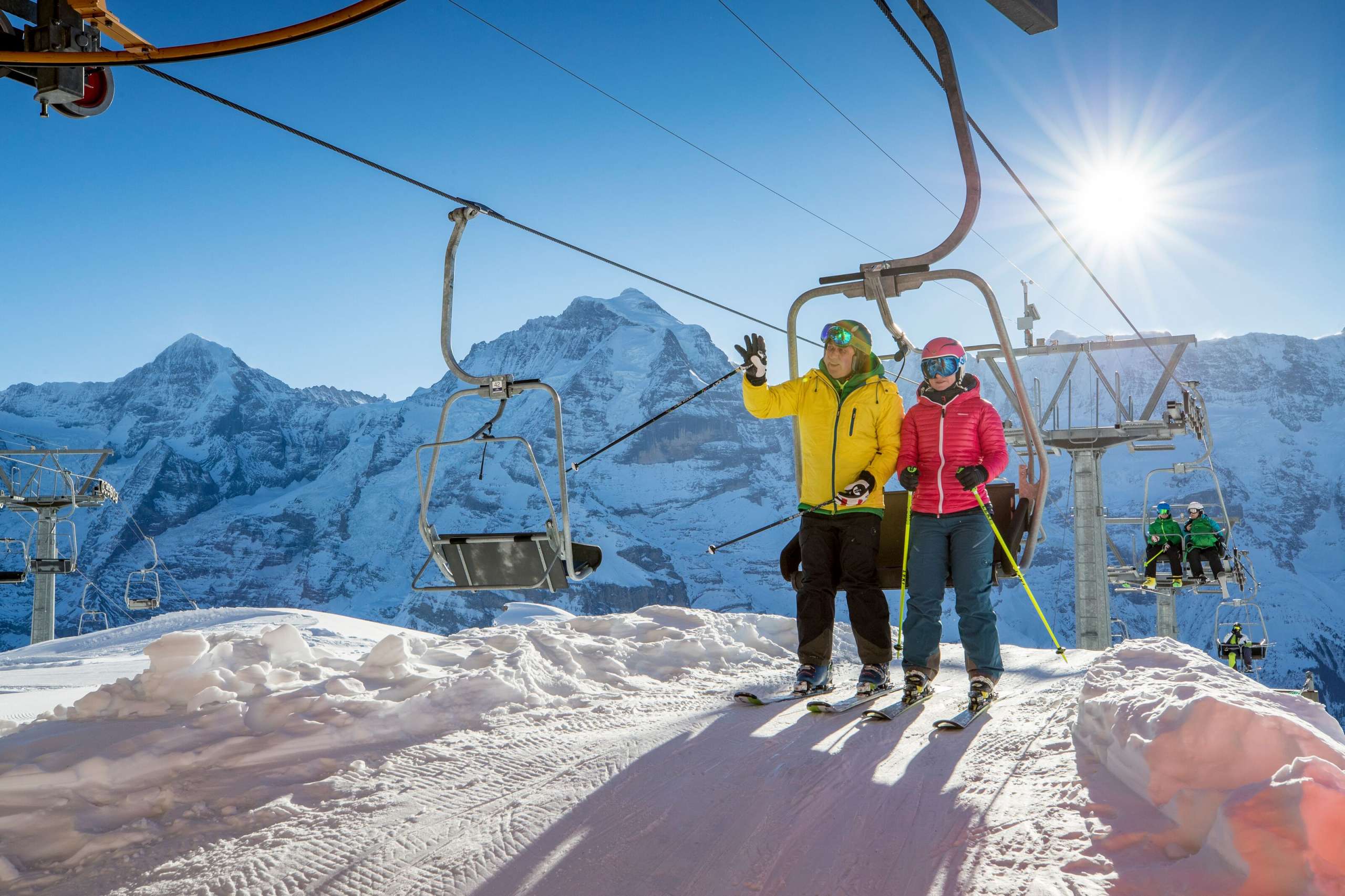 Skiing Mürren-Schilthorn ski area Skiers stand up from the chairlift in the Mürren-Schilthorn ski area. The Eiger, Mönch and Jungfrau triumvirate can be seen from afar.